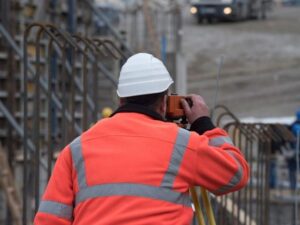 Surveyor performing construction staking and layout work at an advanced manufacturing construction site in North Las Vegas.